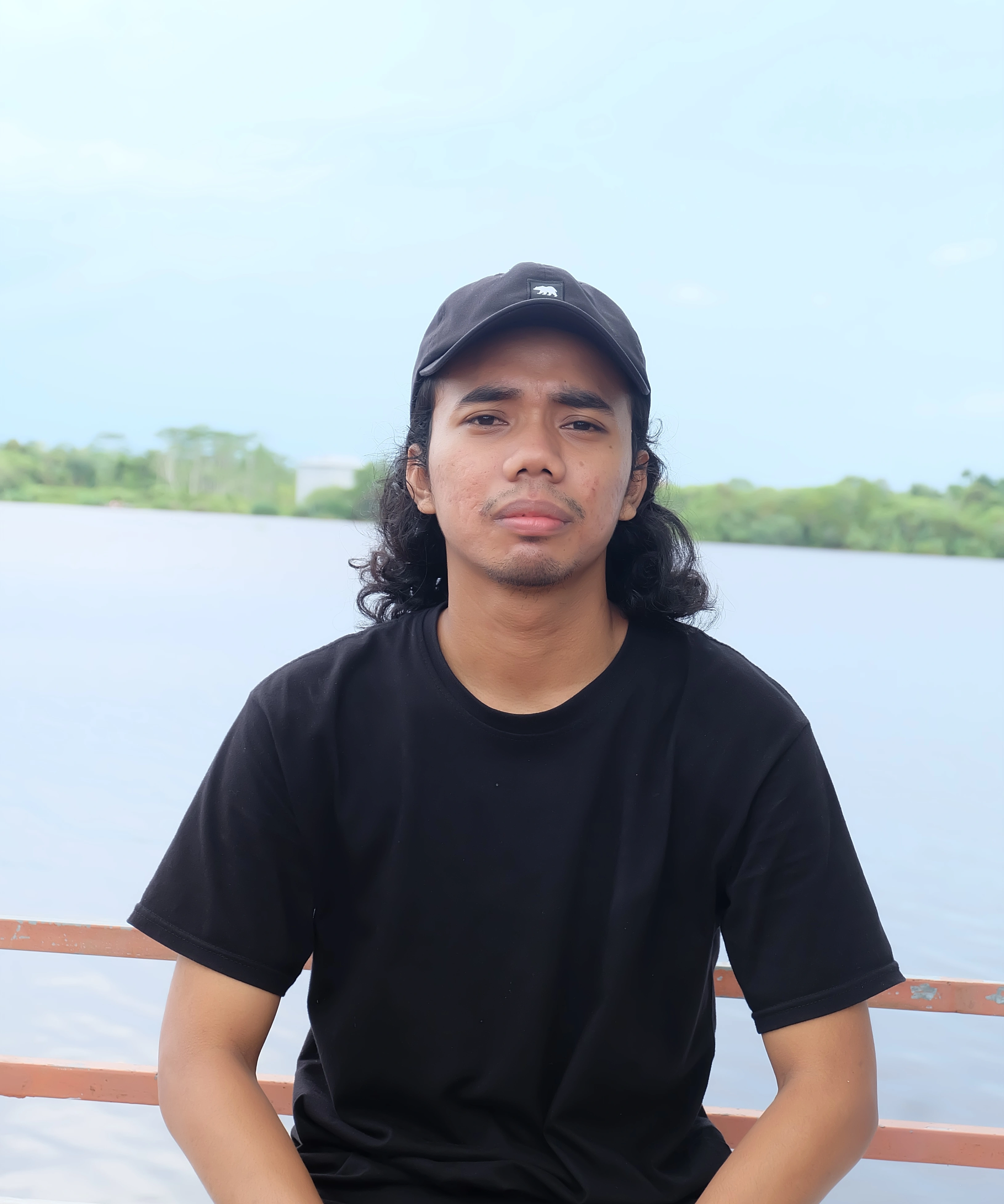 Hutomo smiling in a black shirt